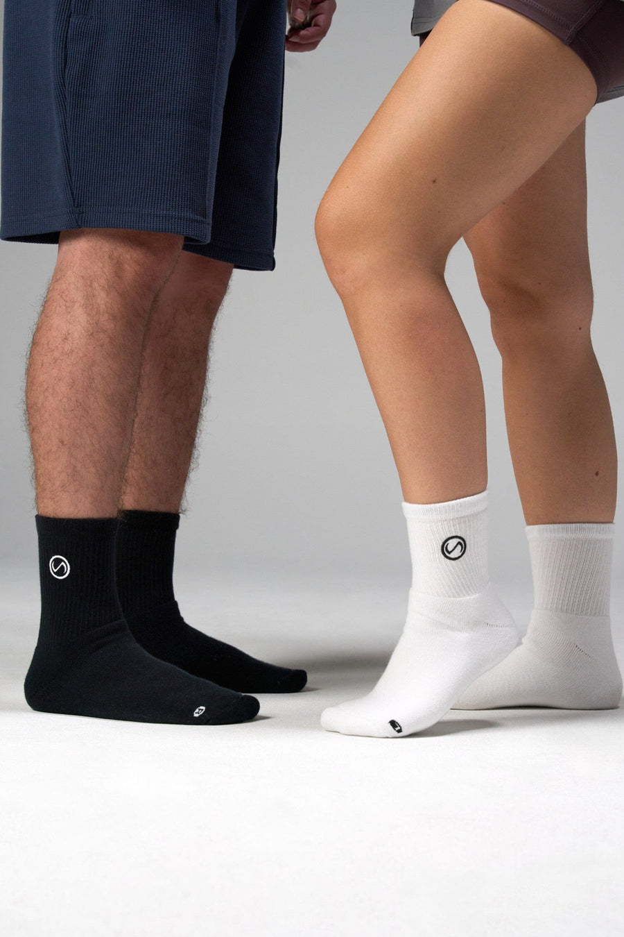 Front View of Black and WhiteTLF Evolve Half Crew Socks featuring an embroidered TLF logo and interiors take life further stitched detailing with a cushioned footbed