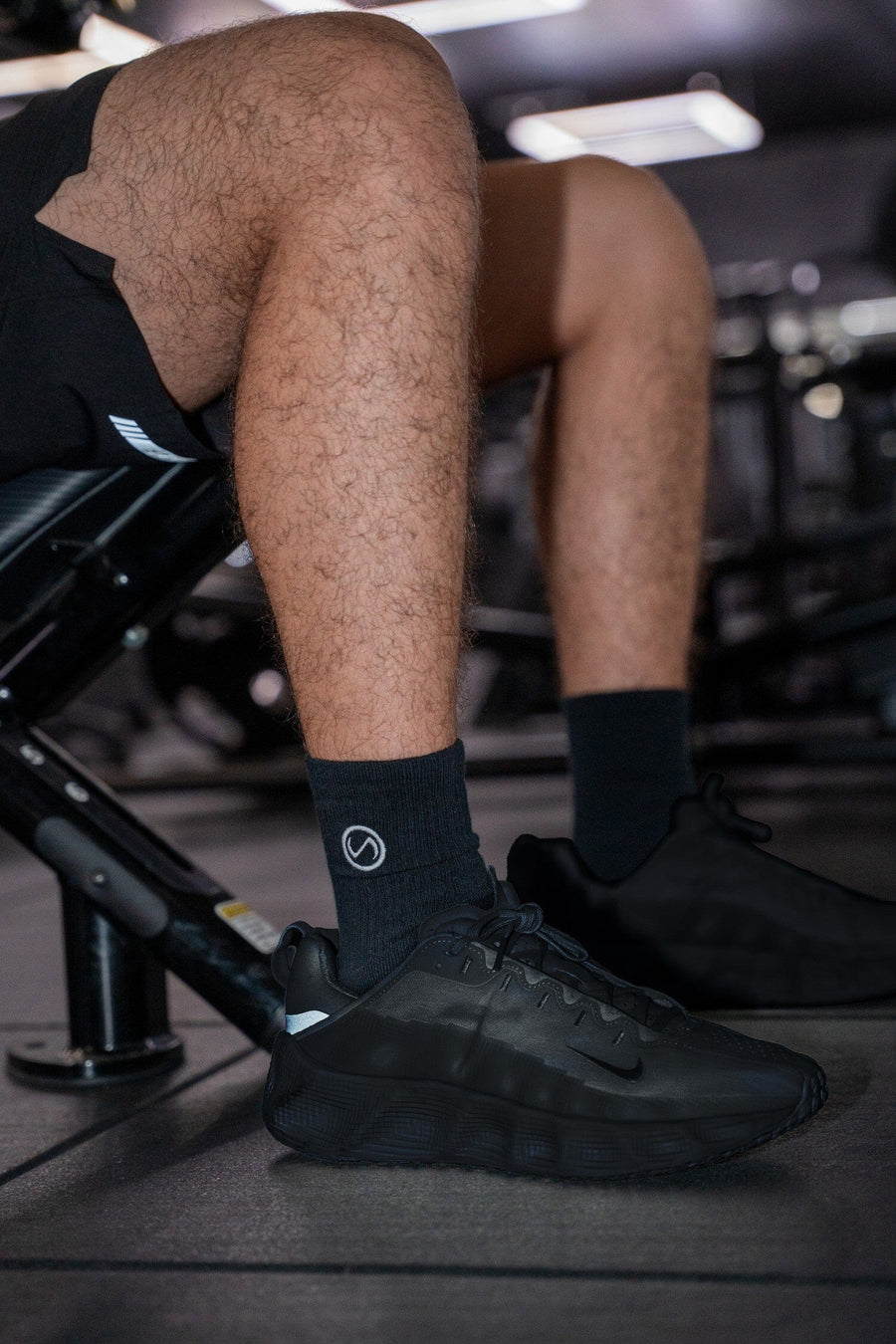 Front View of Black the TLF Evolve Half Crew Socks featuring an embroidered TLF logo and interiors take life further stitched detailing with a cushioned footbed