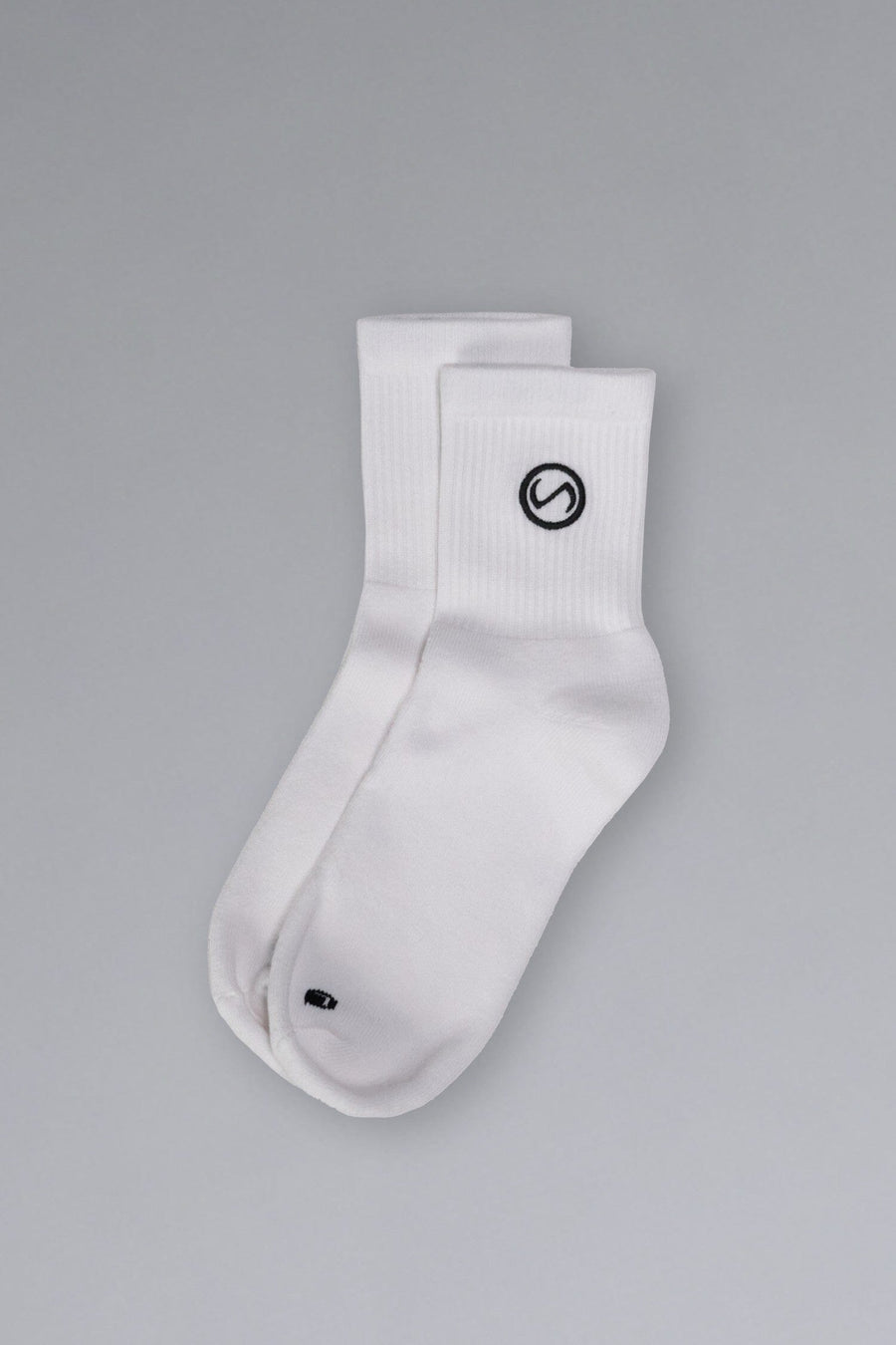 Front View of White TLF Evolve Half Crew Socks featuring an embroidered TLF logo and interiors take life further stitched detailing with a cushioned footbed