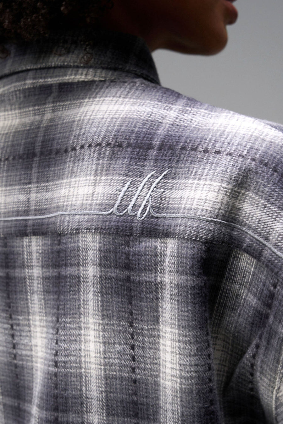 Black View of the Black TLF Flannel Shacket featuring premium embroidery details on the collar and back in a cotton plaid flannel fabric
