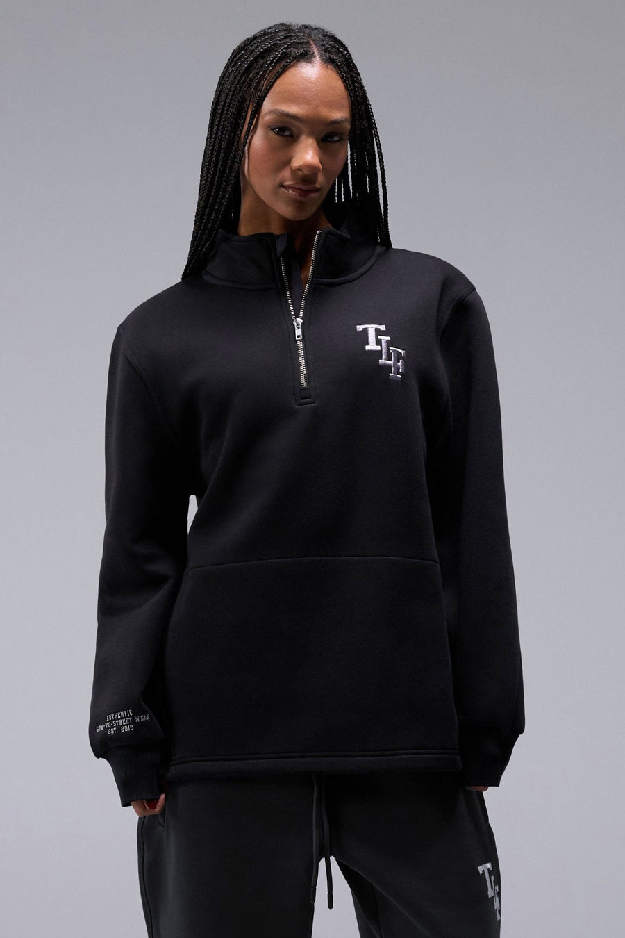 Front View of Black TLF Unisex GTS Scuba Tech Quarter-Zip Pullover, featuring a 1/4 zip pullover sweatshirt with kangaroo pockets