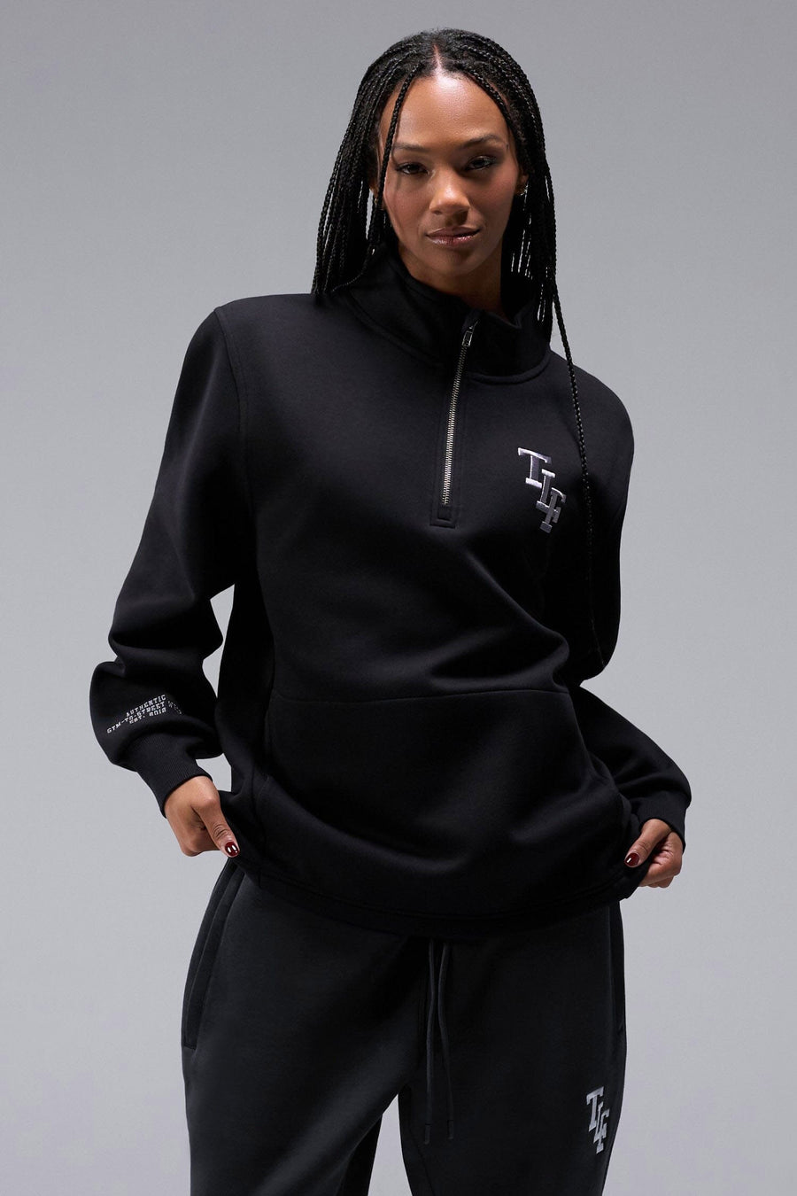 Front View of Black TLF Unisex GTS Scuba Tech Quarter-Zip Pullover, featuring a 1/4 zip pullover sweatshirt with kangaroo pockets