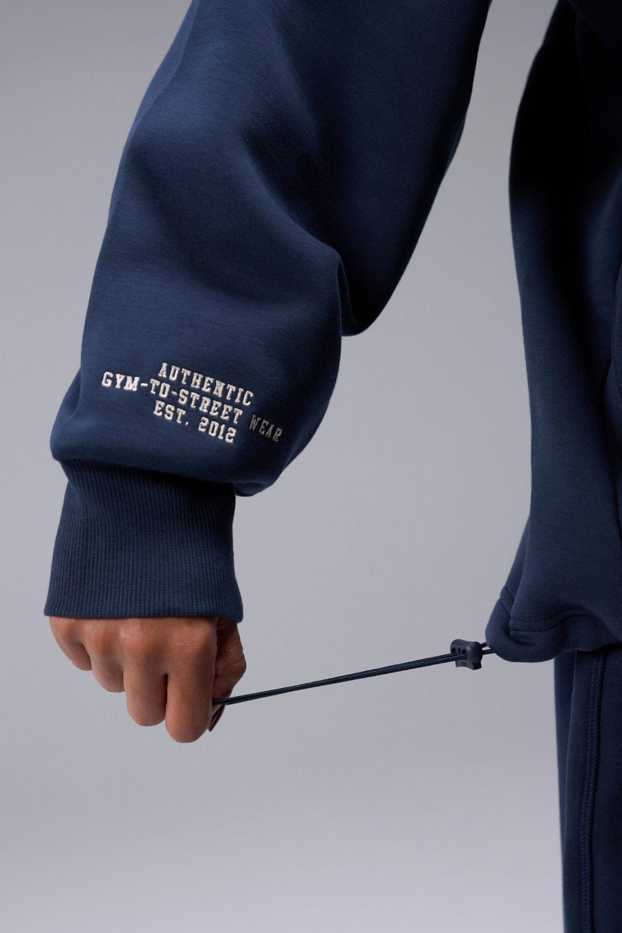 Detail Right Sleeve View of Blue Nights TLF Unisex GTS Scuba Tech Quarter-Zip Pullover, featuring a 1/4 zip pullover sweatshirt with kangaroo pockets