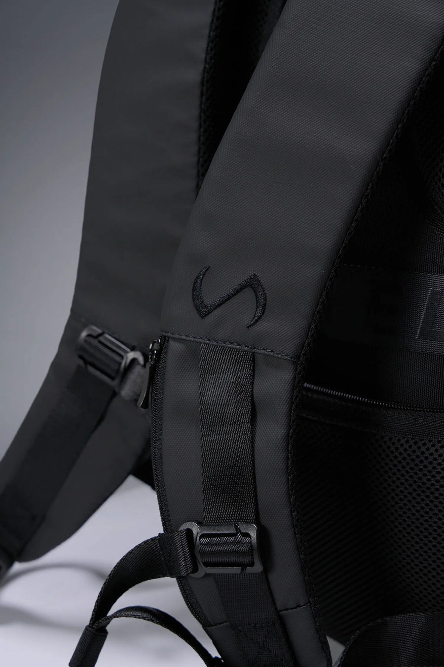 Black Apex Backpack with integrated luggage strap and hidden back zipper pockets for secure storage by TLF Apparel 