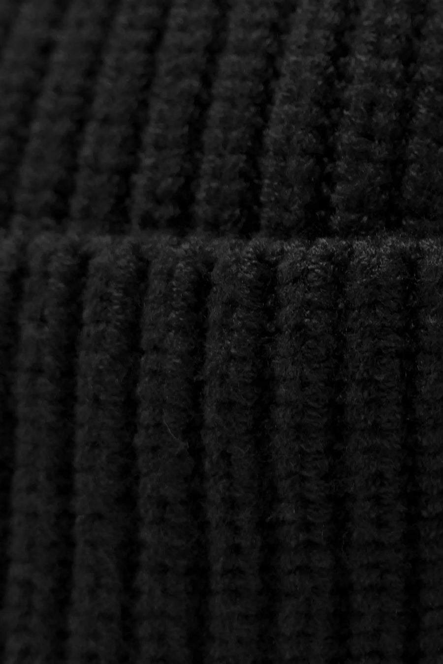 Black Unisex Cuffed Knit Beanie with a fold over cuff, TLF clip label and uses a premium viscose knit fabric blend for premium comfort by TLF Apparel  - fabric close view