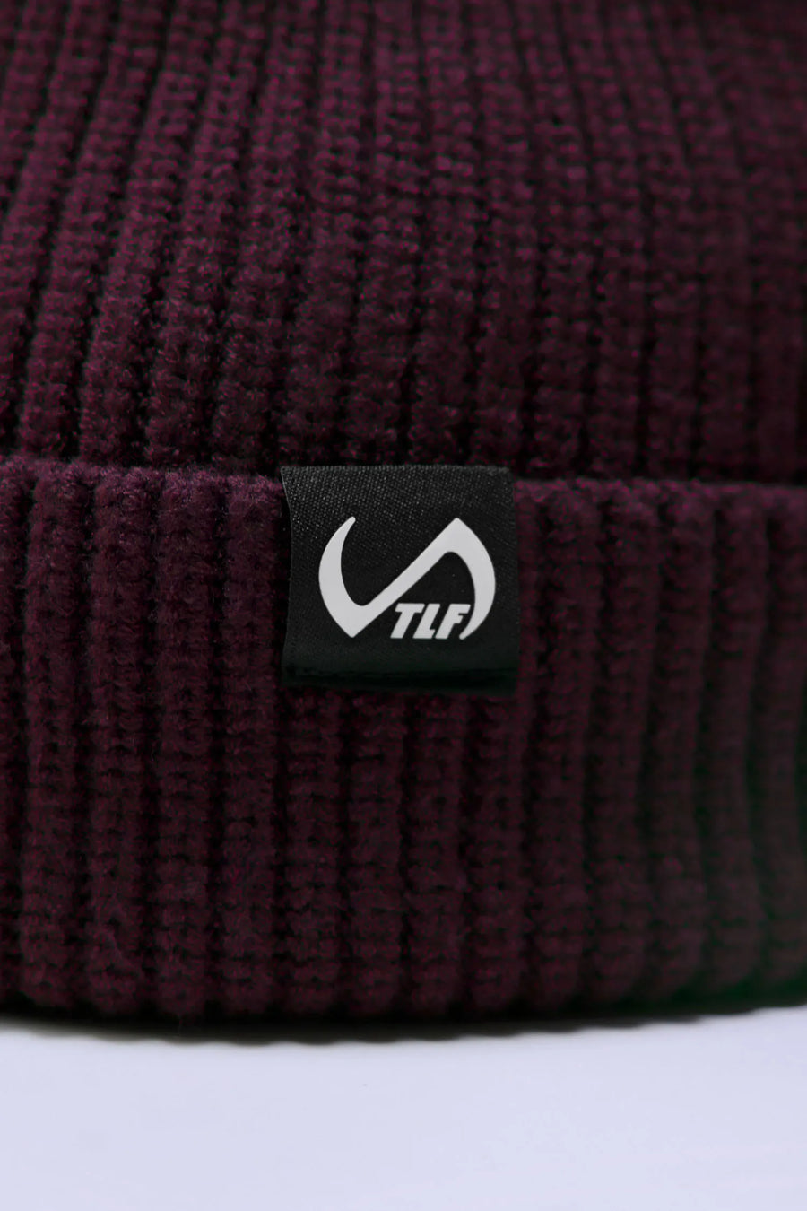 Wine Unisex Cuffed Knit Beanie with a fold over cuff, TLF clip label and uses a premium viscose knit fabric blend for premium comfort by TLF Apparel – close view