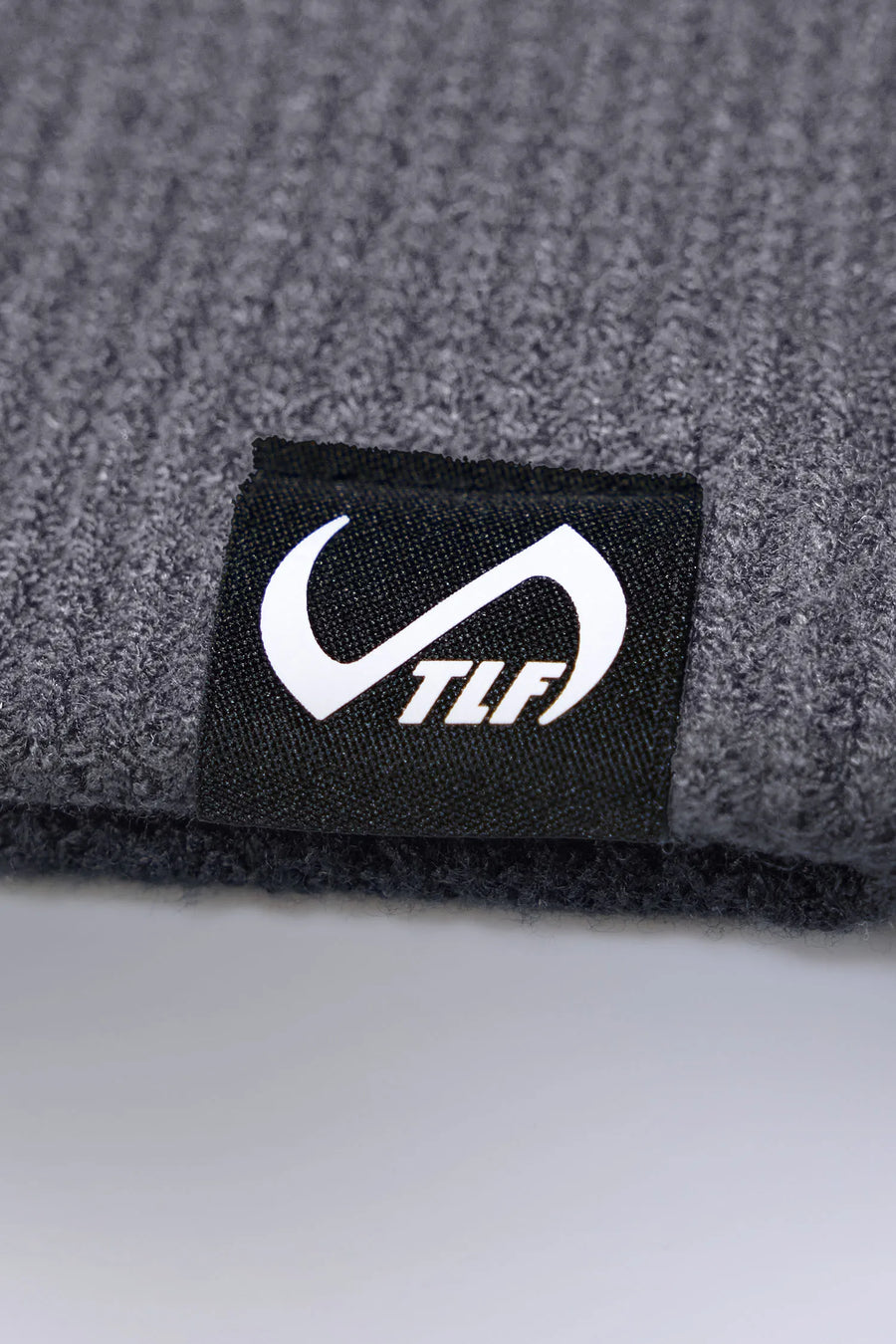 Gray Unisex Knit Skully Beanie features a TLF clip label and uses a premium viscose knit fabric blend for premium comfort by TLF Apparel – front view 