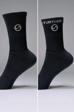 Side View of Black the TLF Evolve Crew Socks featuring an extended cuff height, ribbed cuff, cushioned footbed and seamless toe