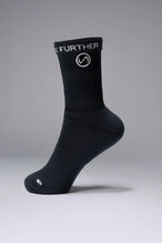 Side View of Black the TLF Evolve Crew Socks featuring an extended cuff height, ribbed cuff, cushioned footbed and seamless toe