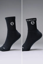 Both Sides View of Black the TLF Evolve Half Crew Socks featuring an extended cuff height, ribbed cuff, cushioned footbed and seamless toe