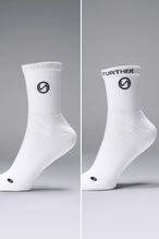 Both Side Views of White the TLF Evolve Half Crew Socks featuring an extended cuff height, ribbed cuff, cushioned footbed and seamless toe