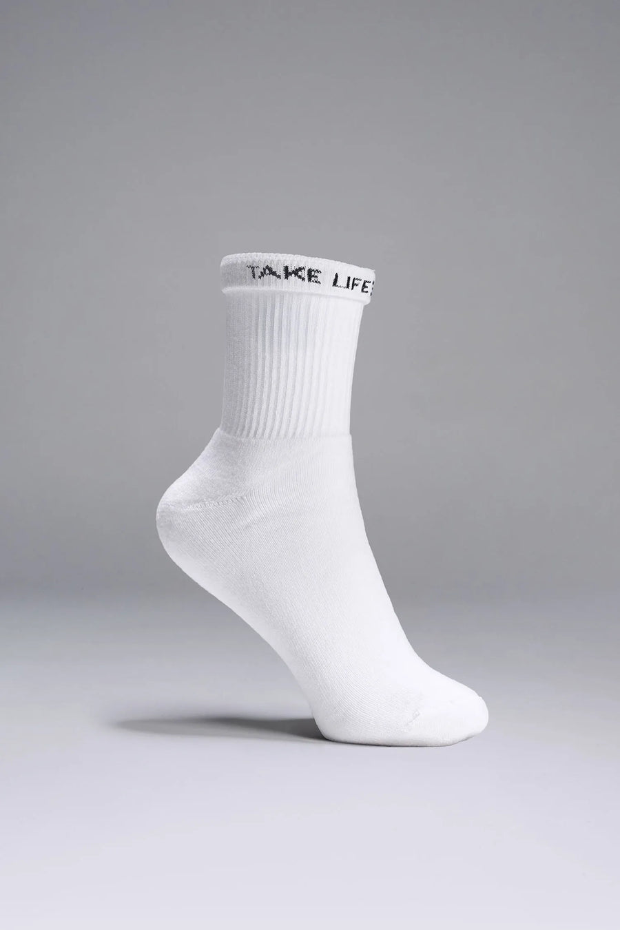 Side View of White the TLF Evolve Half Crew Socks featuring an extended cuff height, ribbed cuff, cushioned footbed and seamless toe