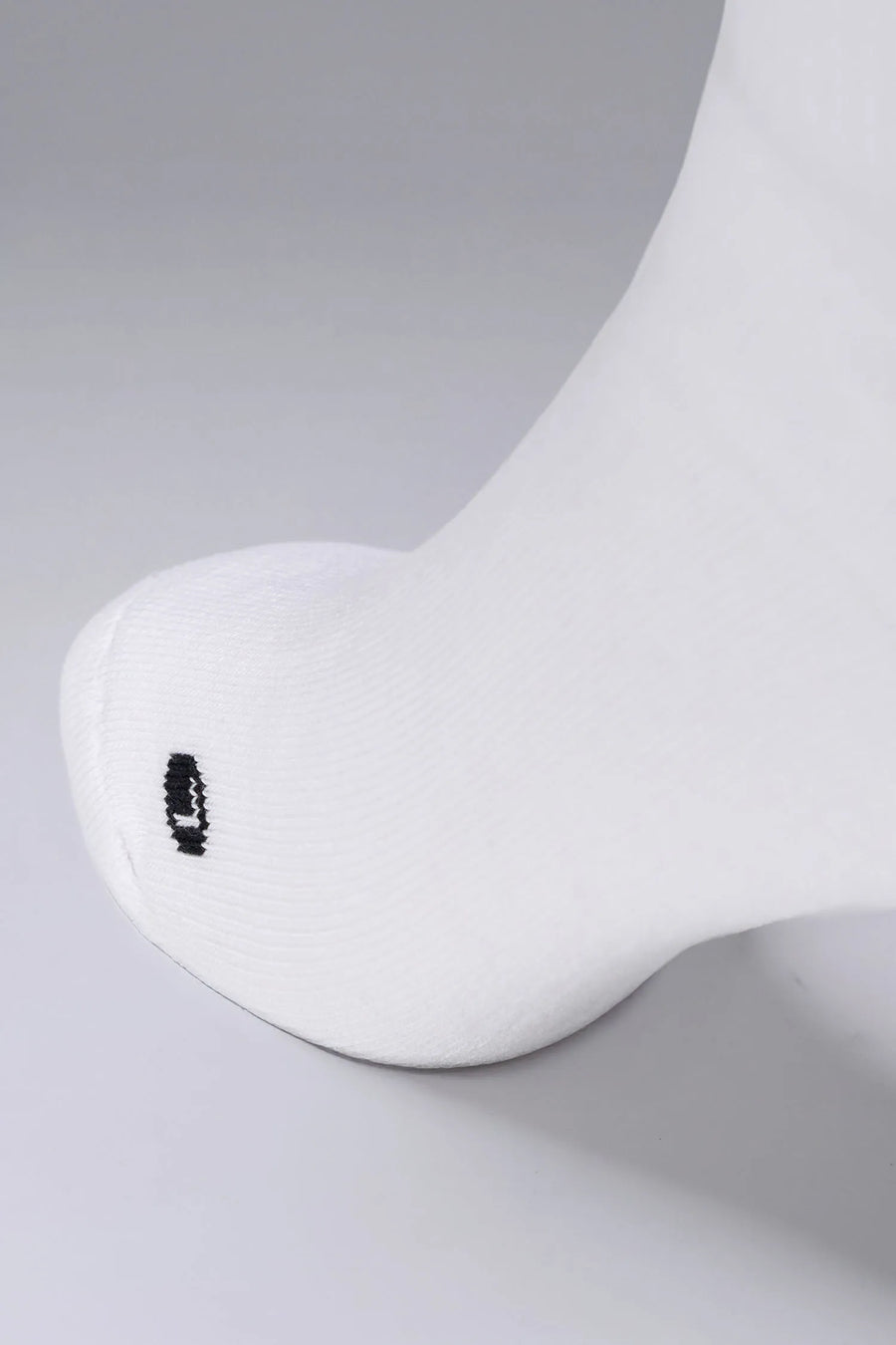 Tow Detail View of White the TLF Evolve Half Crew Socks featuring an extended cuff height, ribbed cuff, cushioned footbed and seamless toe