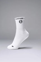 Side View of White the TLF Evolve Half Crew Socks featuring an extended cuff height, ribbed cuff, cushioned footbed and seamless toe