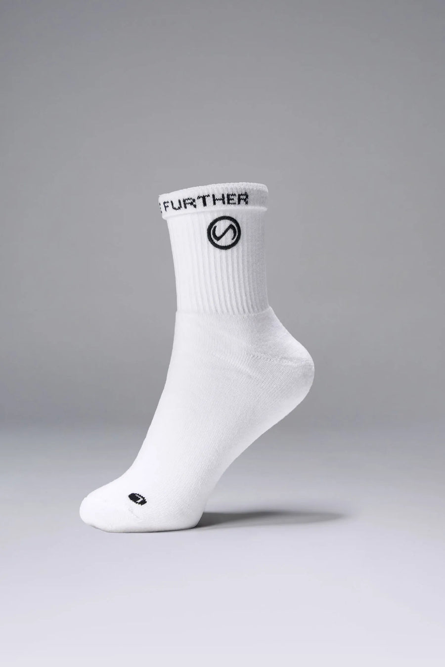 Side View of White the TLF Evolve Half Crew Socks featuring an extended cuff height, ribbed cuff, cushioned footbed and seamless toe