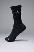 Side View of Black the TLF Evolve Crew Socks featuring an extended cuff height, ribbed cuff, cushioned footbed and seamless toe