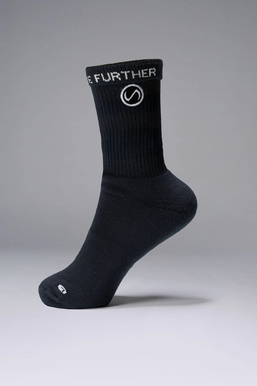 Side View of Black the TLF Evolve Crew Socks featuring an extended cuff height, ribbed cuff, cushioned footbed and seamless toe