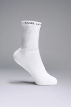 Side View of White the TLF Evolve Crew Socks featuring an extended cuff height, ribbed cuff, cushioned footbed and seamless toe