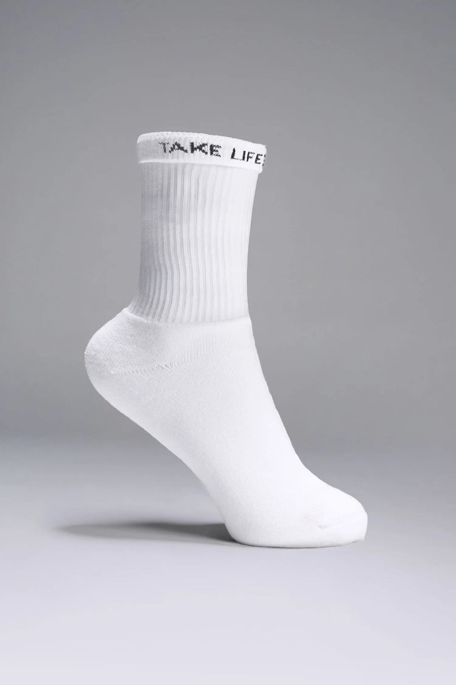 Side View of White the TLF Evolve Crew Socks featuring an extended cuff height, ribbed cuff, cushioned footbed and seamless toe