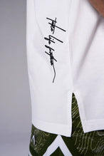 White Classic Script Cotton Luxe Oversized Tee showing left neck icon logo, woven hem clip label, and Cotton Luxe DNA fabric by TLF Apparel – detail view 