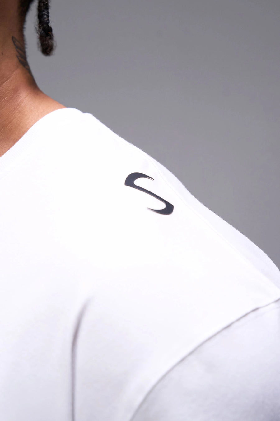 White Classic Script Cotton Luxe Oversized Tee showing left neck icon logo, woven hem clip label, and Cotton Luxe DNA fabric by TLF Apparel – detail view 