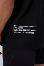Black Take Life Further Oversized Tee showing side split hem, woven hem clip label, and Cotton Luxe DNA fabric by TLF Apparel – detail view 