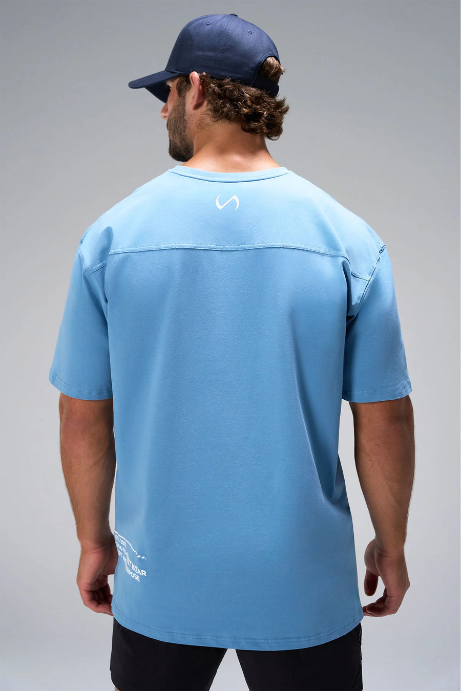 Blue Take Life Further Oversized Tee showing Est 2012 Gym-To-Street back hem callout by TLF Apparel – back view 