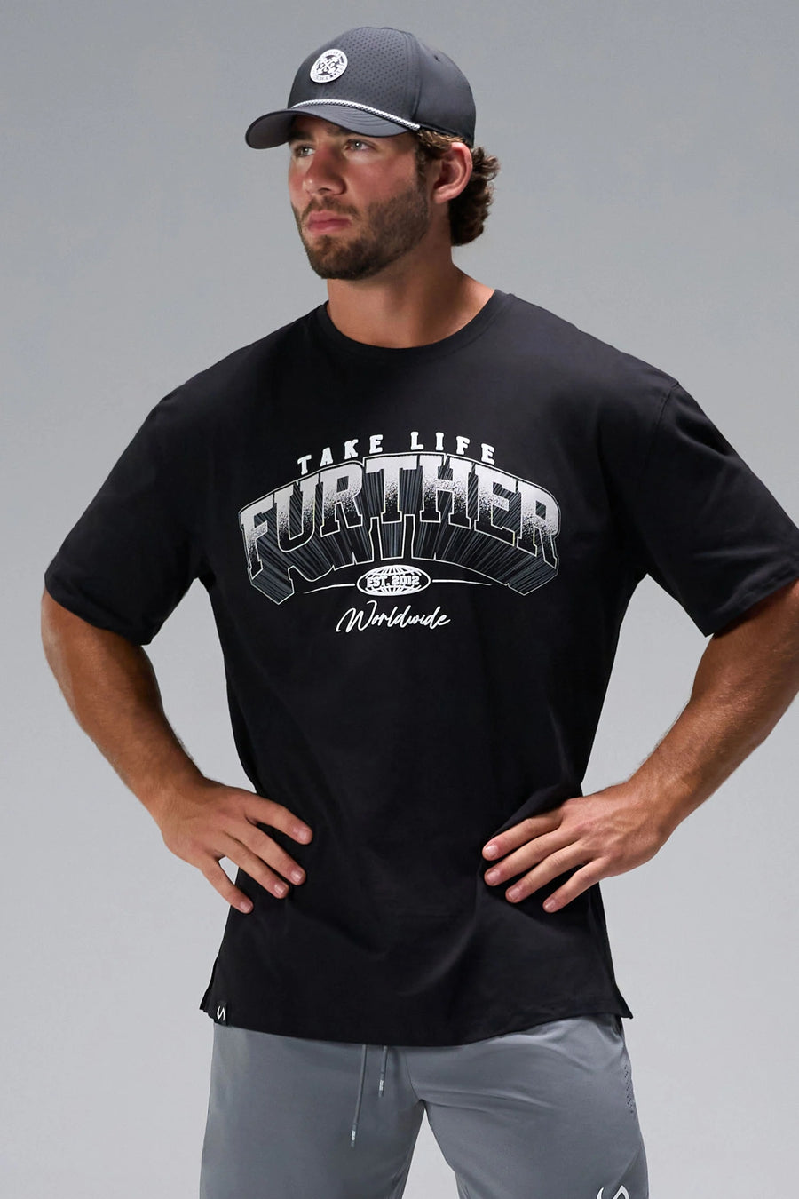 Black Take Life Further Oversized Tee with arched collegiate chest graphic and oversized fit by TLF Apparel – front view 