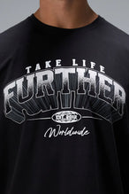 Black Take Life Further Oversized Tee with arched collegiate Take Life Further chest graphic by TLF Apparel – detail view