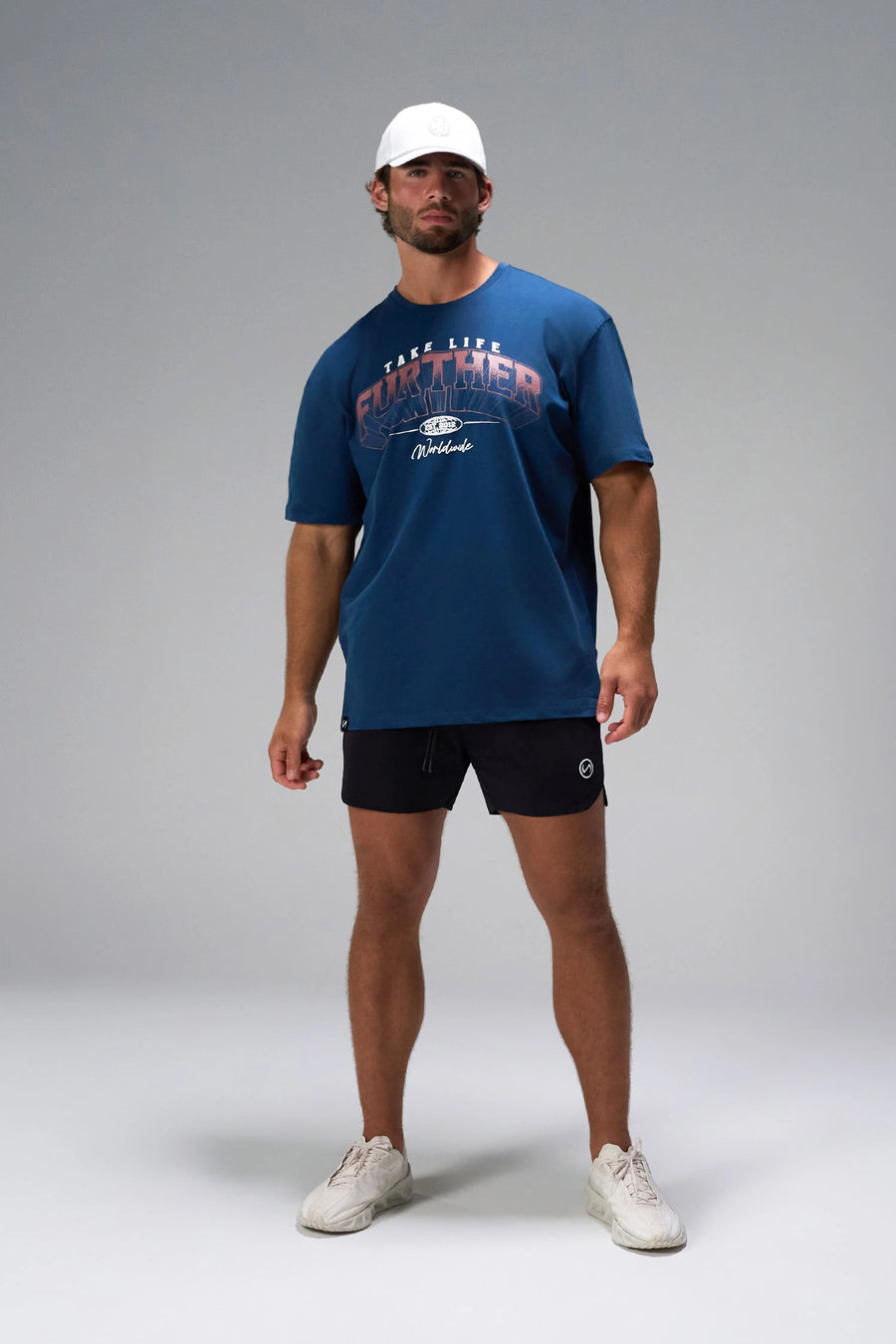 Blue Take Life Further Oversized Tee showing distressed varsity chest print, EST 2012 globe crest, and Cotton Luxe DNA fabric by TLF Apparel – front view 
