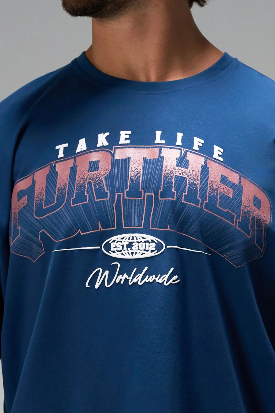 Blue Take Life Further Oversized Tee with arched collegiate Take Life Further chest graphic by TLF Apparel – detail view