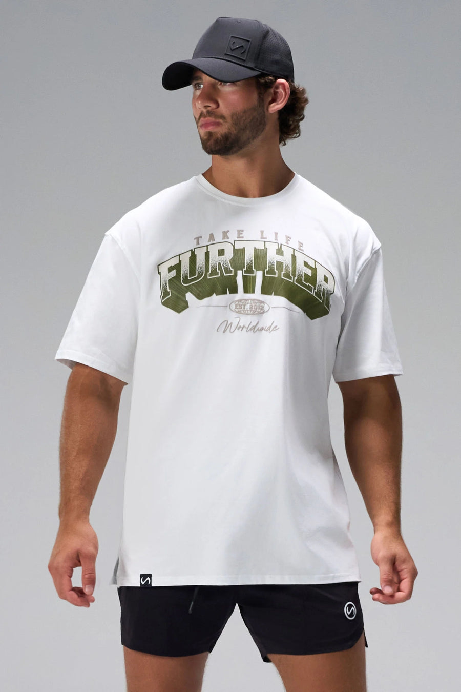 White Take Life Further Oversized Tee with arched collegiate chest graphic and oversized fit by TLF Apparel – front view