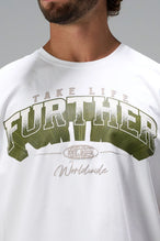 White Take Life Further Oversized Tee showing distressed varsity chest print, EST 2012 globe crest, and Cotton Luxe DNA fabric by TLF Apparel – detail view