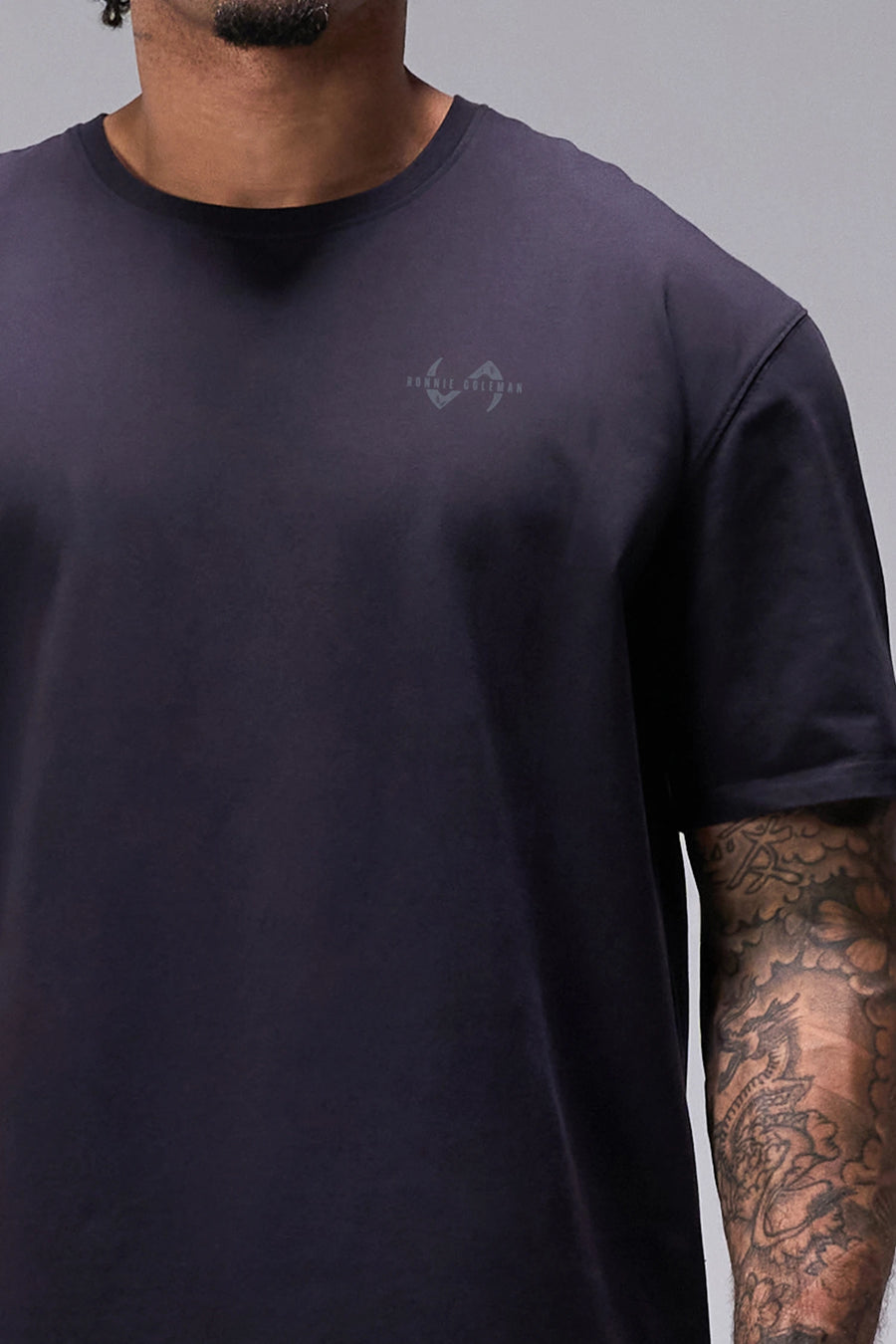 Black Ronnie Coleman “Light weight baby” Tee showing Ronnie Coleman x TLF chest logo and ultra-soft Cotton Luxe DNA™ fabric by TLF Apparel – front detail view