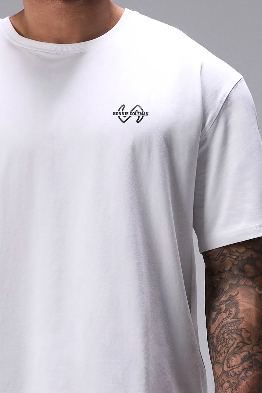 White Ronnie Coleman “Level Up” Tee showing Ronnie Coleman x TLF chest logo and ultra-soft Cotton Luxe DNA™ fabric by TLF Apparel – front detail view