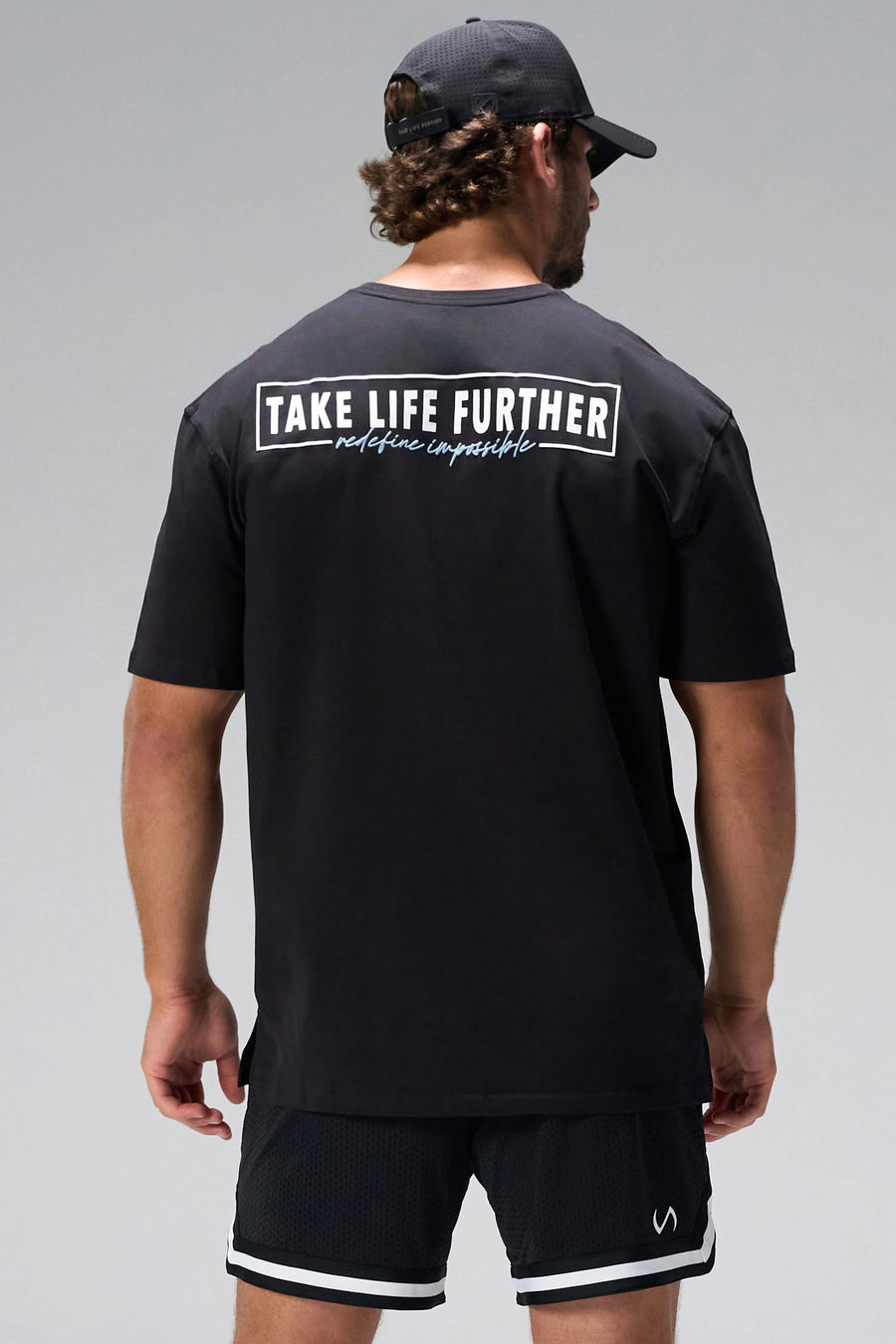 Black Statement Cotton Luxe Oversized Tee showing Take Life Further back graphic and oversized fit by TLF Apparel – back view 