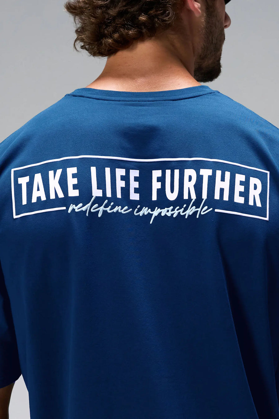 Blue Statement Cotton Luxe Oversized Tee with statement Take Life Further upper back graphic by TLF Apparel – back view 