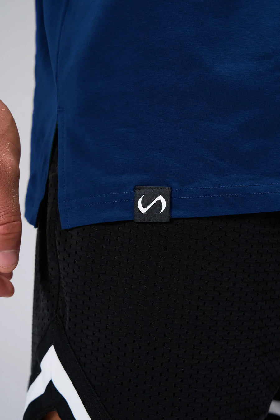 Blue Statement Cotton Luxe Oversized Tee showing side split hem, woven hem clip label, and Cotton Luxe DNA fabric by TLF Apparel – detail view