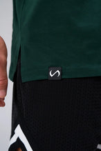 Green Statement Cotton Luxe Oversized Tee showing side split hem, woven hem clip label, and Cotton Luxe DNA fabric by TLF Apparel – detail view