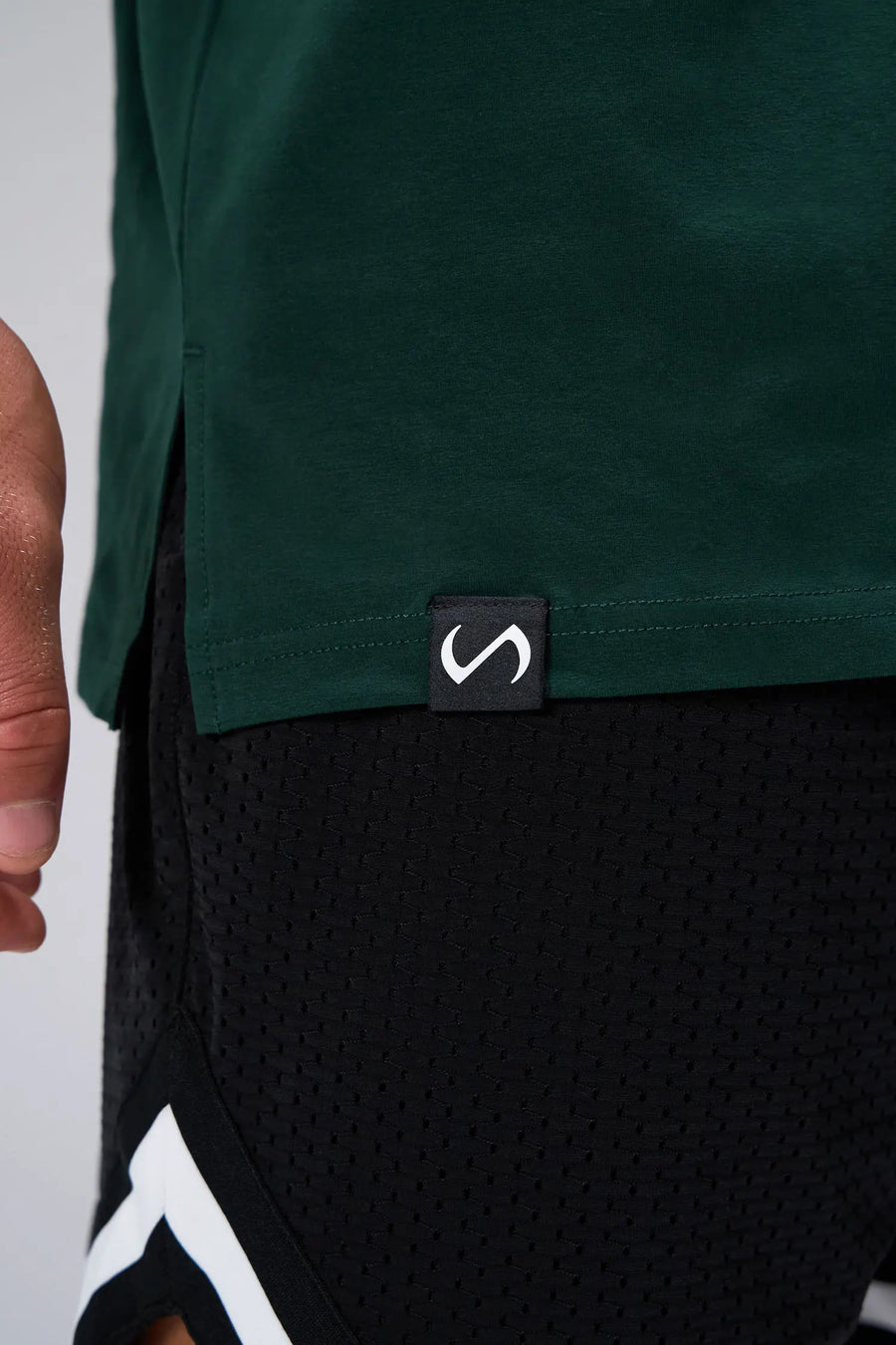 Green Statement Cotton Luxe Oversized Tee showing side split hem, woven hem clip label, and Cotton Luxe DNA fabric by TLF Apparel – detail view
