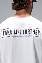 White Statement Cotton Luxe Oversized Tee showing side split hem, woven hem clip label, and Cotton Luxe DNA fabric by TLF Apparel – detail view