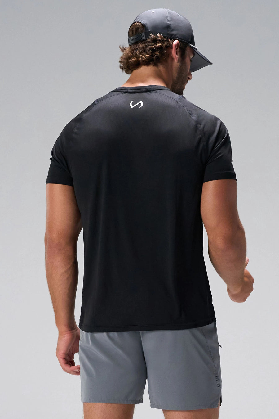 Black Pluma Sun Tee showing upper back logo and breathable Pluma Tech DNA fabric by TLF Apparel – back view