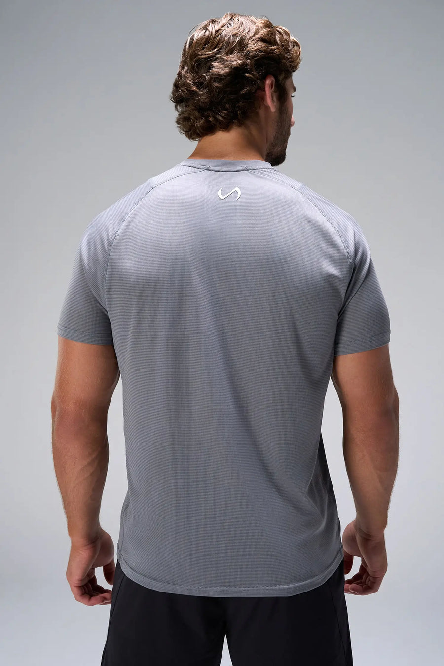 Quiet Shade Pluma Sun Tee showing upper back logo and breathable Pluma Tech DNA fabric by TLF Apparel – back view