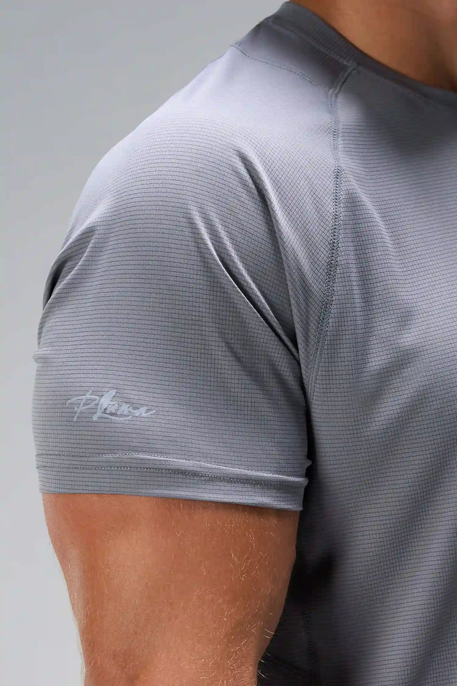 Quiet Shade Pluma Sun Tee showing UV color-changing arm logo and micro-grid knit fabric by TLF Apparel – detail view
