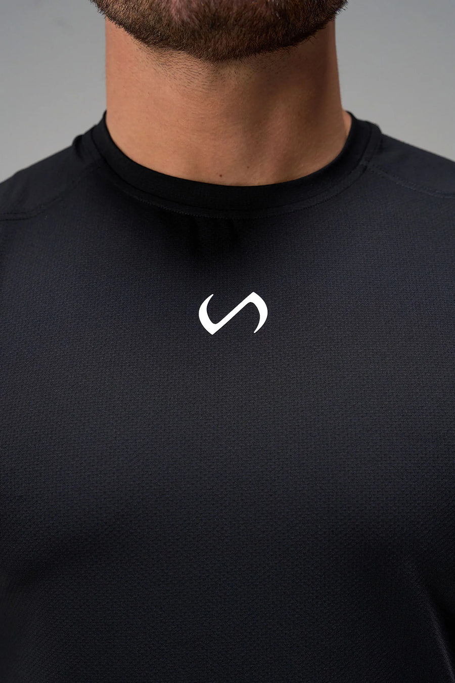 Black Men’s Micro Mesh Tee with a physique-enhancing fit, designed for gym training, HIIT workouts and running by TLF Apparel – front view 