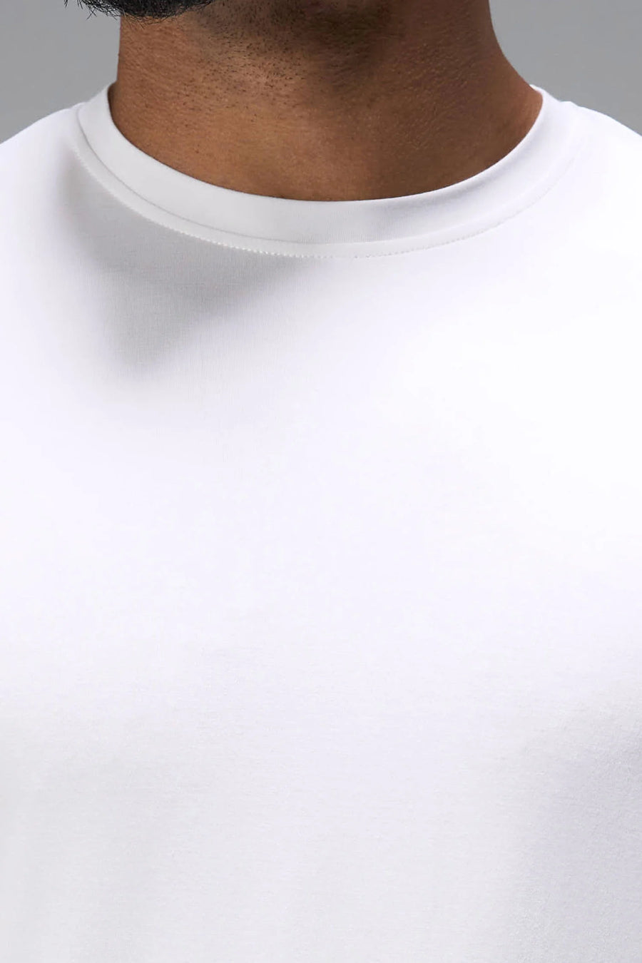 White Bamboo Crew Neck Essential Tee showing ultra soft bamboo fabric texture and silicone icon label detail by TLF Apparel – detail view
