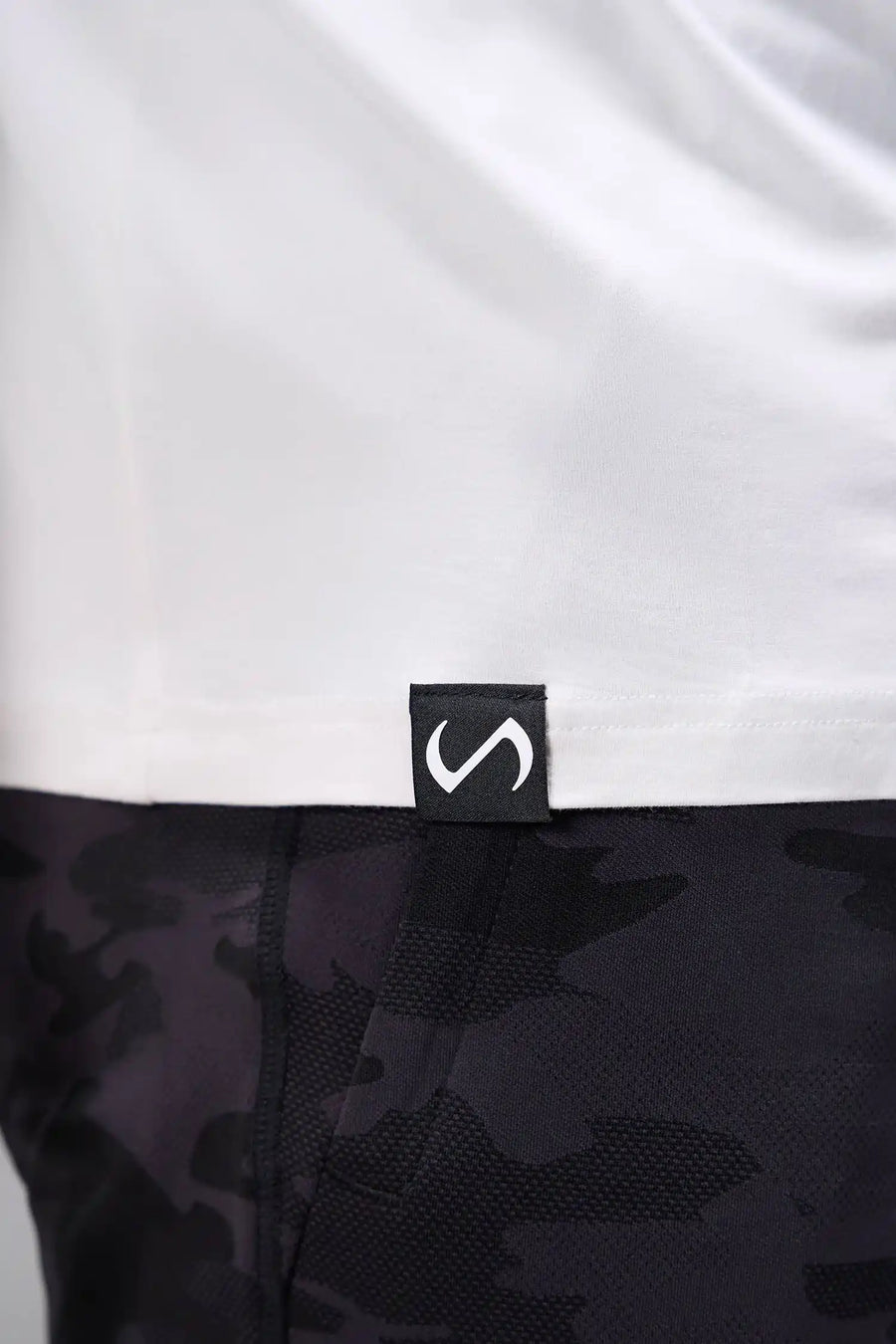 White Bamboo V Neck Essential Tee showing ultra soft bamboo fabric texture and silicone icon label detail by TLF Apparel – detail view