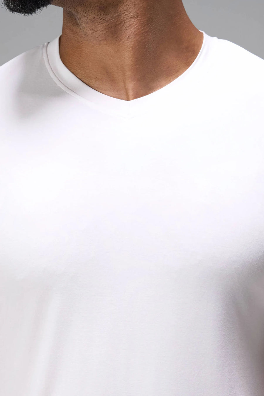 White Bamboo V Neck Essential Tee showing ultra soft bamboo fabric texture and silicone icon label detail by TLF Apparel – detail view