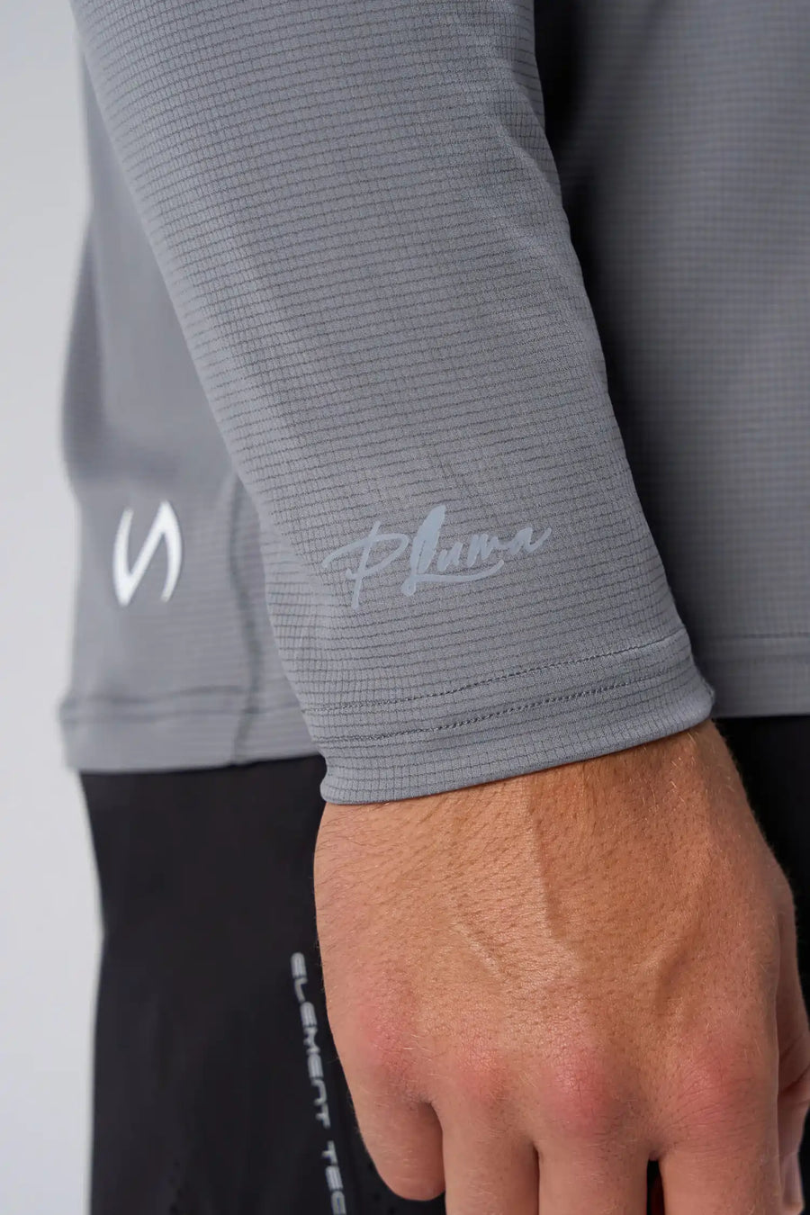 Gray Pluma UPF Sun Hoodie showing UV color-changing wrist logo and micro-grid knit fabric by TLF Apparel – detail view