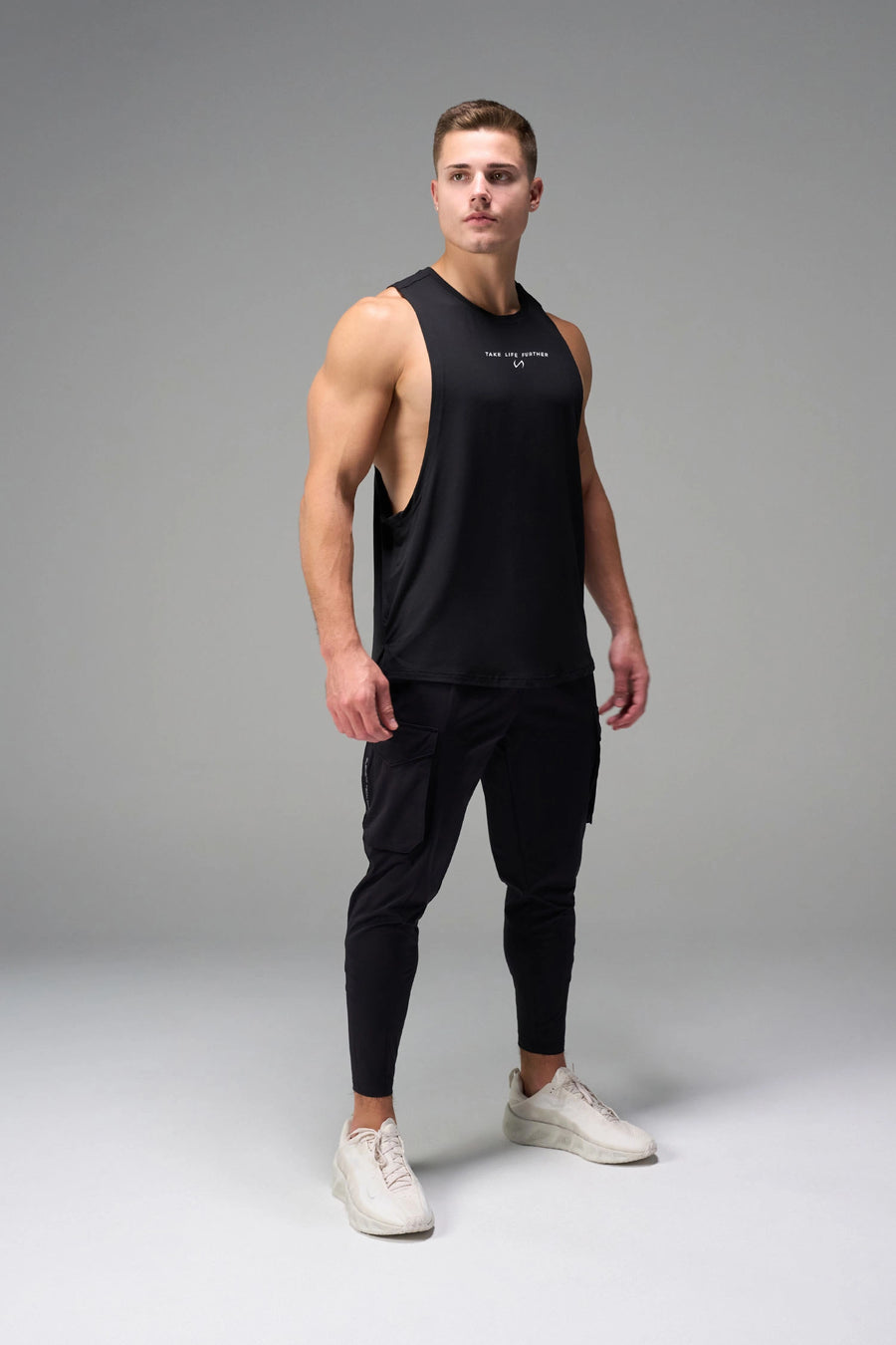 Black Further Air-Flex Drop Arm Tank showing drop arm silhouette and breathable performance fabric by TLF Apparel – side view